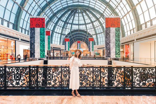 Tourist girl taking selfie photo in one of the largest shopping centers in Dubai - Emirates Mall. Travel destinations in UAE