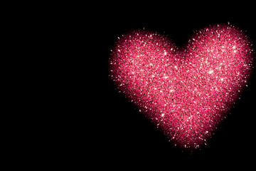 abstract background with pink heart isolated on black, shiny heart with glitter effect