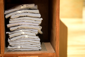 Stock of yukata on wood shelf