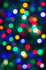 Fototapeta premium Beautiful bright abstract texture - colorful bokeh. Background for holiday, new year, christmas. Vertical photo