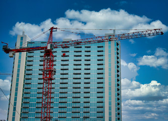 Fototapeta na wymiar Highrise tower behind construction crane