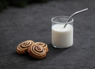 Cookies twisted with cinnamon and milk festive on a dark background, Christmas and New Year