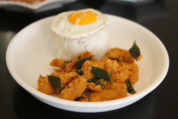 Crispy chicken rice served with sunny side up egg. Front View