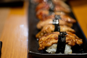 Foie gras sushi on black dish