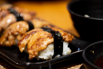 Foie gras sushi on black dish
