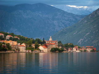 Fototapeta na wymiar city in Kotor bay on the sunset with beautiful mountains