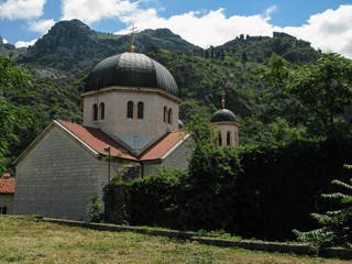 Fototapeta na wymiar Church of St. Nicholas in the old town of Kotor against the backdrop of mountains and fortress, Montenegro