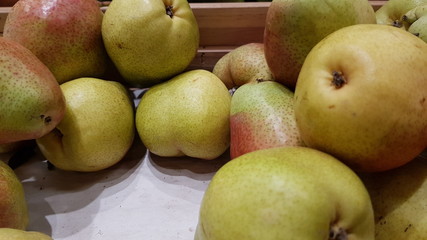 Green pears in a crate for display at supermarket