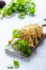 Grilled herbed tofu with avocado cream,  vegan meal, plant based diet