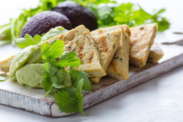 Grilled herbed tofu with avocado cream,  vegan meal, plant based diet