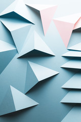 Abstract pattern made of colored paper, light blue background