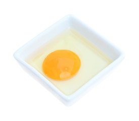 Raw egg in rectangle plate on white background.