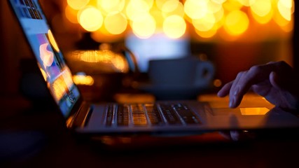 Woman scrolling gallery of items in online e-commerce on her laptop making some purchases for Christmas and New Year celebrations. UHD