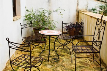 Outdoor terrace with iron furniture. Andalusia Spain
