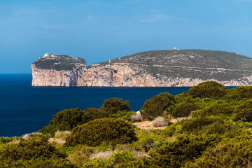 The coastline of Capo Caccia, a promontory near Alghero, as seen from Punta Giglio (Sardinia, Italy)