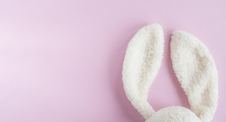 Easter flat lay with bunny rabbit white ears on pink  background,  top view,  copy space.  