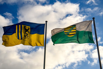 Leipzig City Flag and Saxony Land Flag against a blue sky.