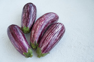 Striped eggplants on white background