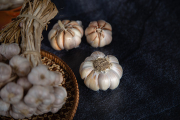 Garlic is placed on the black table in the kitchen, preparing for cooking,