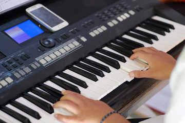 Fototapeta na wymiar Musician's hand playing a keyboard instrument.