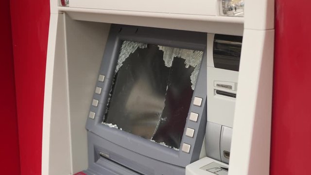 Cash machine with smashed glass.
