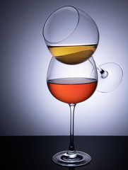 two wine glasses with red and white wine