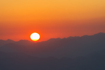 scenery sunrise above the mountain ridge on Doi Pha Phung at Nan province in Thailand.
