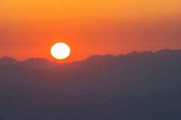 scenery sunrise above the mountain ridge on Doi Pha Phung at Nan province in Thailand.