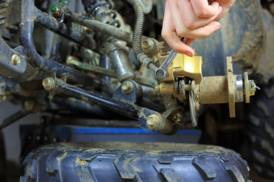 Mechanic Carrying Out Repairs On A Quad Bike