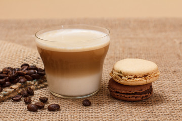 Coffee cappuccino and coffee beans on sackcloth background