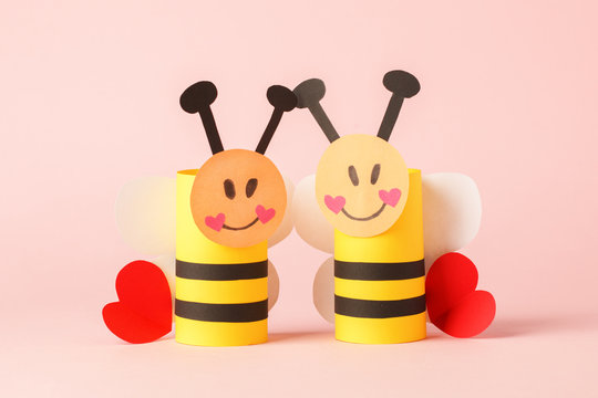 Couple of bee in love, concept of man and woman together with hearts on pink background. Concept of happy Valentines day, diy, toilet roll toy. Recycle reuse handmade decor