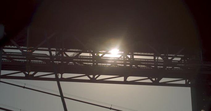 Sunset on the suspension bridge structure. Reveal shot