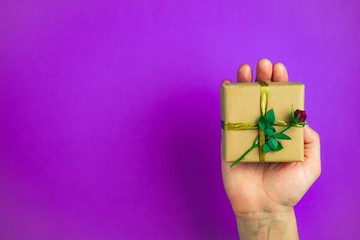 Male hand holding gift box.