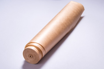 Roll of baking paper on grey background