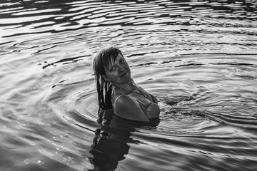 Girl in the water. Splashes, drops and beautiful girl