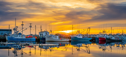 sunset at the wharf where the lobster boats are berthed.