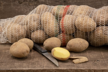 Fresh potatoes on wooden table