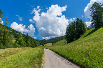 Road with a beautiful view. Santa Maddalena village, Dolomites, Val di Funes, Italy.