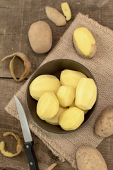 Raw potatoes on wooden table, Top view