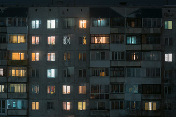 Facade of building at night light in the windows