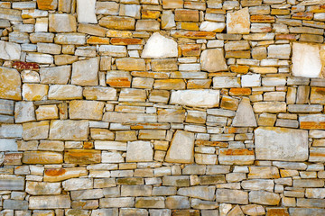 Wall of stones as a texture. Stone wall. Wall of stones. wall of a medieval fortress with mainly...