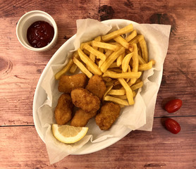 Crispy Breaded Chicken Nuggets with French Fries and Ketchup.