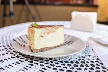 Philadelphia cheesecake on a table in a cozy chocolate bar. Tasty food.