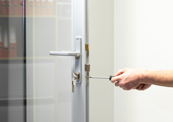 glass Door knob repairing , worker Installs door knob, woodworker hands close-up - 312245532