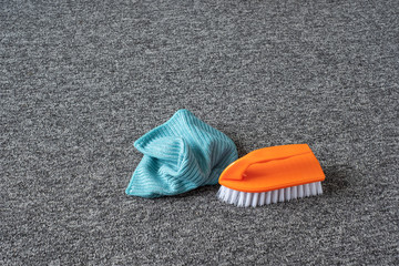 cleaning brush and microfiber cloth on the gray carpet - 312245589