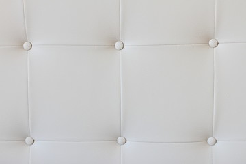 white leather background with knobs