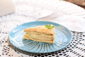 Napoleon cake on the table in a cozy chocolate bar. Tasty and not healthy food.