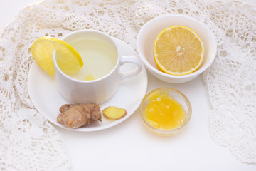 ginger tea with lemon and honey. Tea for immunity, a cold drink. ginger tea in a white cup on a white background. The concept of winter, health, immunity. A healthy detox drink.