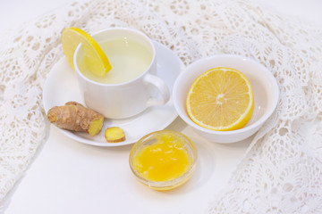 ginger tea with lemon and honey. Tea for immunity, a cold drink. ginger tea in a white cup on a white background. The concept of winter, health, immunity. A healthy detox drink.