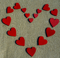 many red hearts on the beach